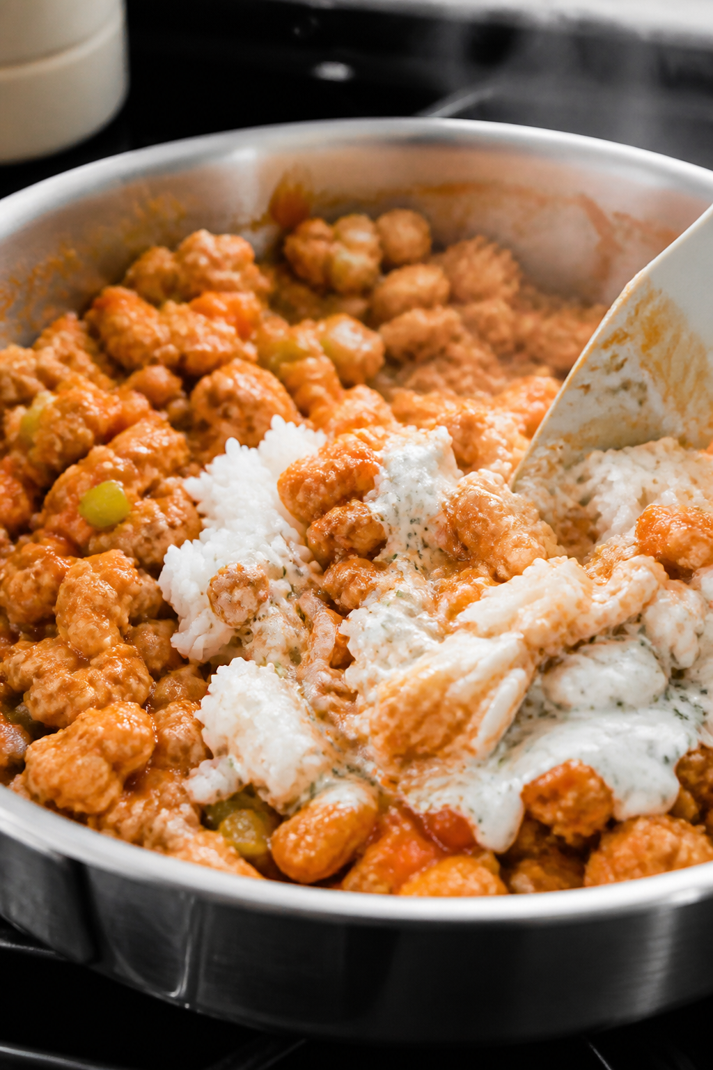 Cooking process close-up: Ground turkey mixture simmering in a stainless skillet after browning, coa