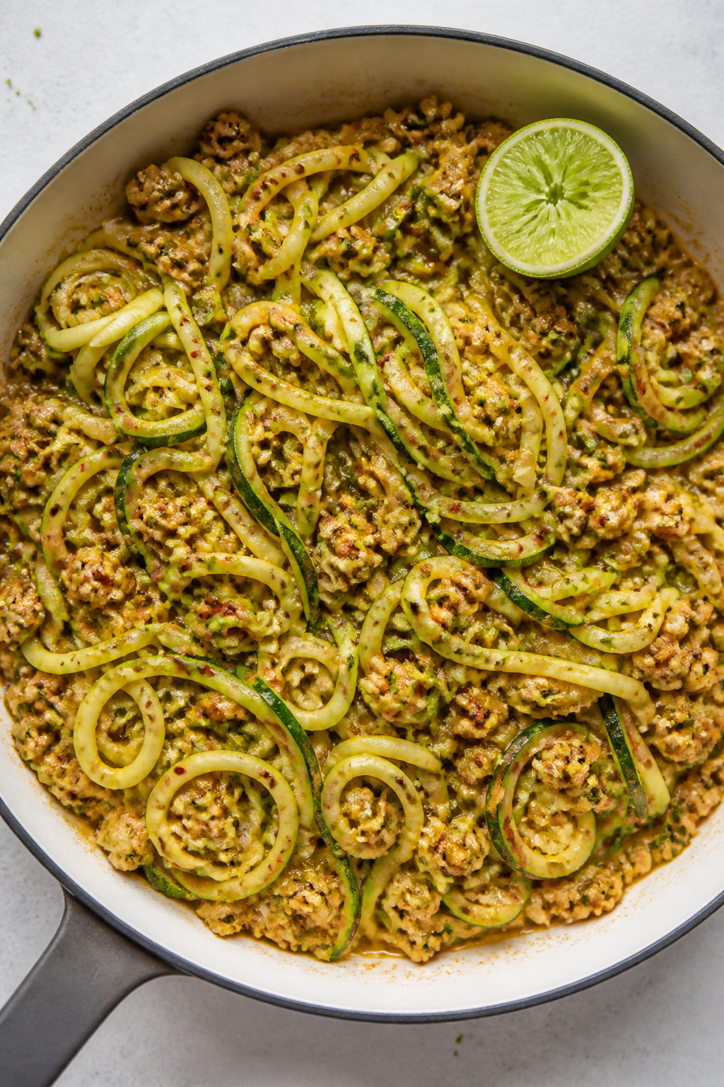 Cooking process: Zucchini noodles just folded into the spiced turkey mixture in a large skillet, str