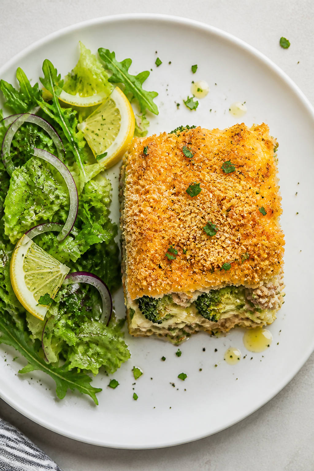 Tasty top view: Overhead shot of a plated serving of Ground Turkey Broccoli Cheddar Bake on a matte 