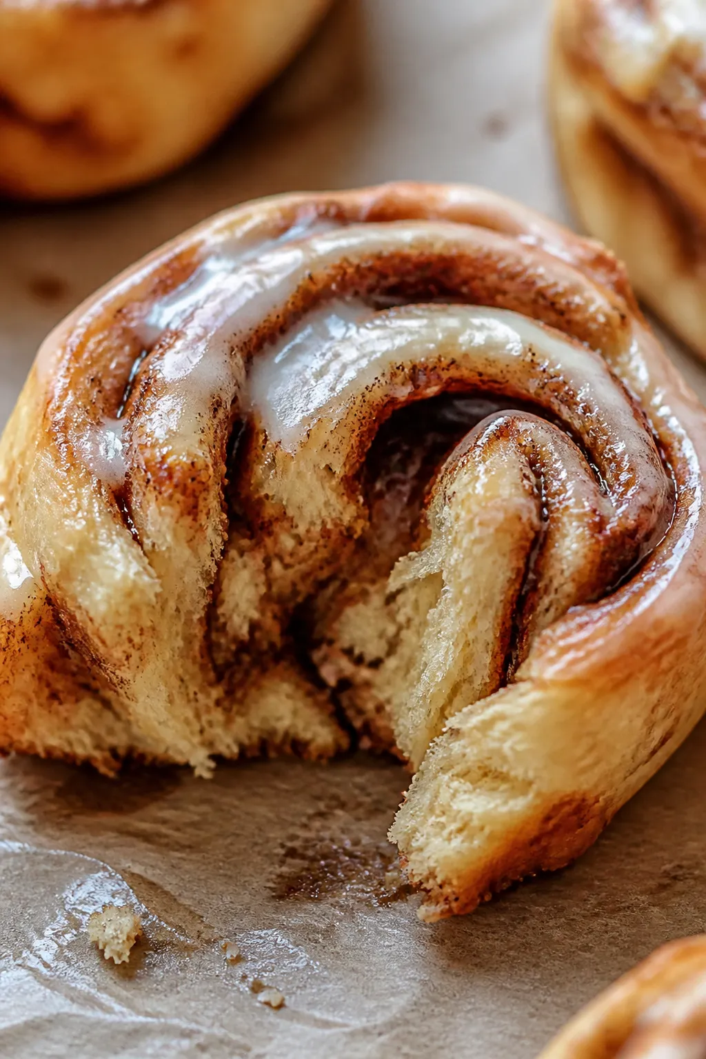 Close-up detail: A just-baked keto cinnamon roll torn open to reveal the soft, slightly chewy interi