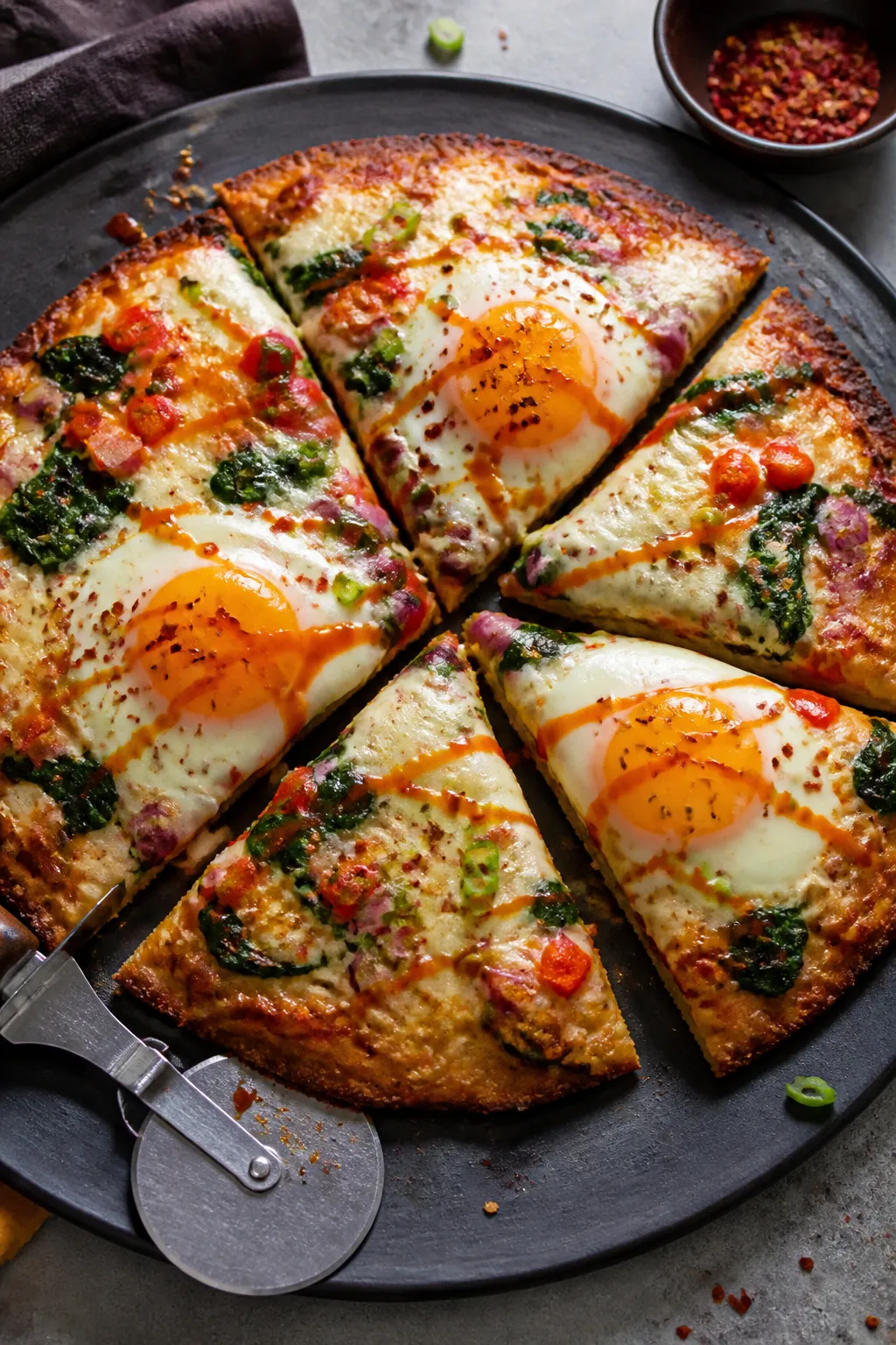Final dish presentation: Restaurant-quality hero shot of the baked Keto Breakfast Pizza sliced, with