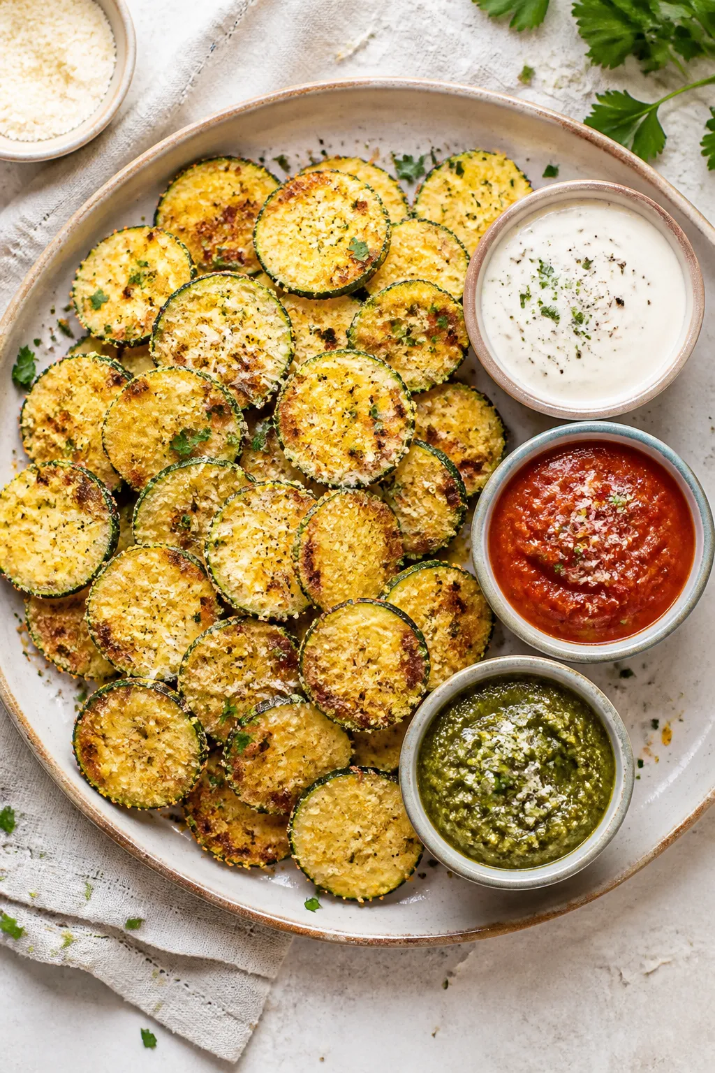 Tasty top view final presentation: Overhead shot of a rustic platter piled with Keto Parmesan Zucchi