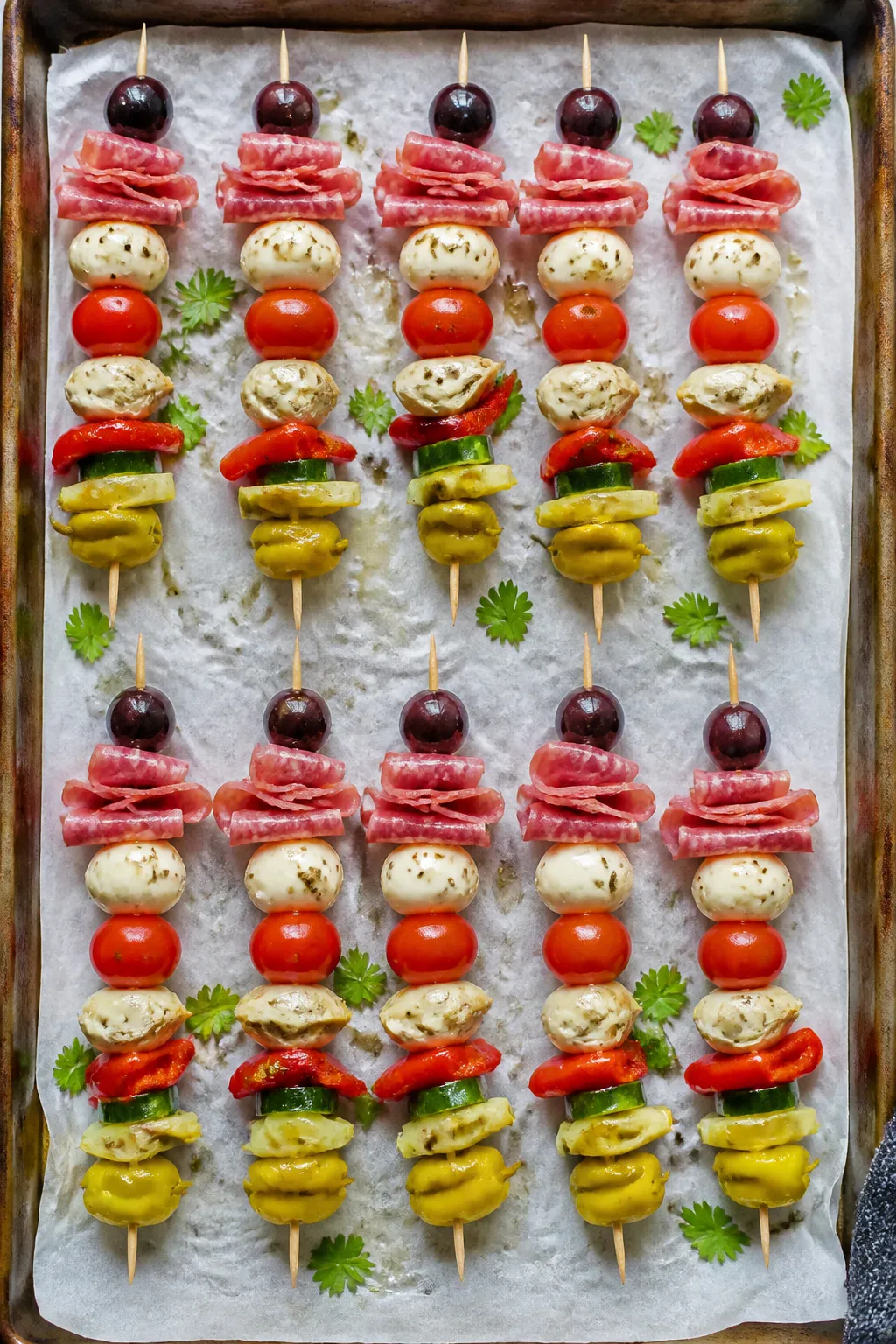 Tasty top view: Overhead shot of neatly aligned Keto Italian Antipasto Skewers on parchment over a r