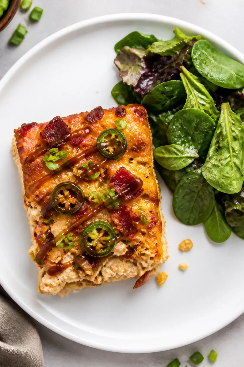 Tasty top view, overhead slice: Overhead shot of a neatly cut square of keto BBQ chicken casserole o
